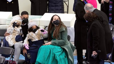 Members of Kamala Harris's family talk with New York Senator Chuck Schumer during the inauguration. AP