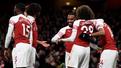 Arsenal players celebrate with Alexandre Lacazette, centre, after his goal in their win over Newcastle United. EPA