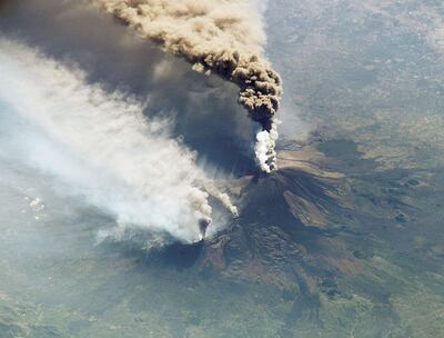 Smoke and ash erupt from Mount Etna in 2002, in a photo taken from the International Space Station. Getty Images