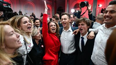 Supporters of Poland's centrist opposition celebrate after an exit poll showed it was on course to topple the government after a record turnout. Getty Images