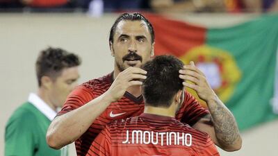 Portugal's Hugo Almeida celebrates with Portugal midfielder Joao Moutinho after Almeida scores against Ireland in the first half of their international friendly on Tuesday ahead of the 2014 World Cup in Brazil. Ray Stubblebine / Reuters / June 10, 2014