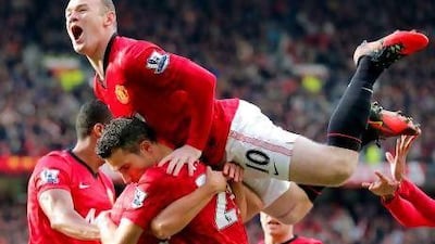 Robin van Persie, centre bottom, is mobbed by his Manchester United teammates after opening the scoring yesterday. Kerim Okten / EPA