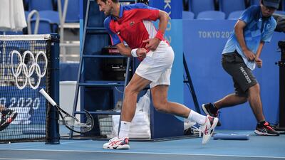 Novak Djokovic smashes his racket during his Tokyo 2020 Olympic Games bronze medal match against Spain's Pablo Carreno Busta.