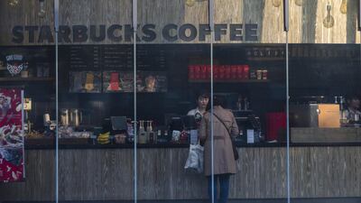 A customer stands at the counter of a Starbucks Corp. store in the Shibuya district of Tokyo, Japan, on Thursday, Nov. 16, 2017. Japan’s economy grew for a seventh straight quarter, its longest expansion since 2001, as a recovery in exports and rising business investment offset a decline in consumer spending. Photographer: Keith Bedford/Bloomberg