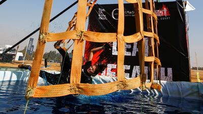 A competitor takes a tumble during Egypt's Tough Mudder challenge. Organisers say the event is not a race, but a way for participants to have fun and challenge themselves. Reuters