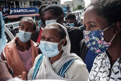 People listen as staff members of the National Electoral Board of Ethiopia explain how to vote for the upcoming general election. AFP