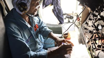 A Vietnamese Air Force officer in a search and rescue aircraft takes notes as he searches for a missing Malaysia Airlines plane, 250km from Vietnam and 190km from Malaysia. Reuters