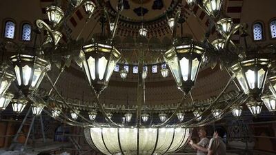 Workers are fix parts of the chandelier at the under construction Farooq Mosque in Al Safa area in Dubai.