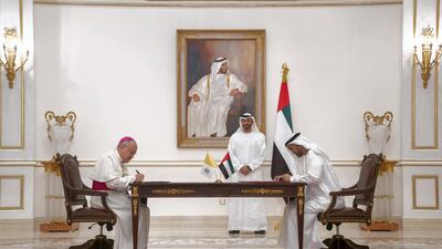 Sheikh Mohamed bin Zayed looks on as Mohamed Al Mazrouei, Undersecretary of the Crown Prince Court of Abu Dhabi, and Archbishop Francisco Montecillo Padilla, personal envoy of Pope Francis, sign the declaration. Rashed Al Mansoori / Ministry of Presidential Affairs