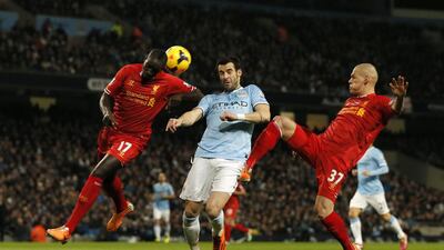 Liverpool's Mamadou Sakho, left, and Martin Skrtel challenge Manchester City's Alvaro Negredo during their English Premier League match on Thursday. Phil Noble / Reuters