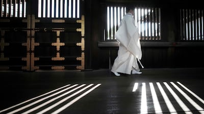 A Shinto priest walks along a corridor of Yasukuni Shrine in Tokyo. AFP
