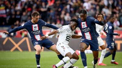 Paris Saint-Germain's Fabian Ruiz, left, tussles with Rennes' Arnaud Kalimuendo. AFP