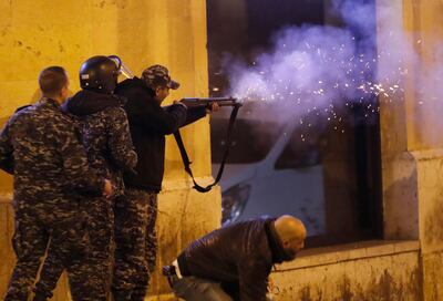 Riot police fire rubber bullets towards anti-government protesters trying to enter a square in central Beirut. AP