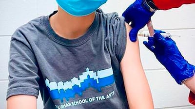 A boy receives an injection during a trial of the Pfizer-BioNTech coronavirus vaccine among children aged between 12 and 15, at Duke University in the US.