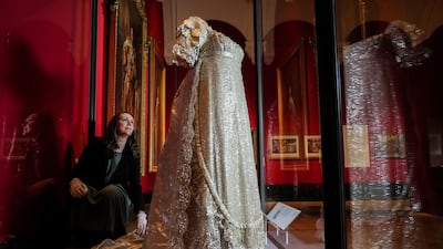 NOTE: Images shall be solely used for news editorial purposes only in connection with the exhibition Style & Society: Dressing the Georgians at The Queen's Gallery, Buckingham Palace. Anna Reynolds, exhibition curator, adjusts the earliest surviving British royal wedding dress, worn by Princess Charlotte of Wales at her wedding to Prince Leopold of Cobourg in 1816, on display during the preview of the Style & Society: Dressing the Georgians exhibition at The Queen's Gallery, Buckingham Palace in London. The exhibition is set to "reveal life in the 18th century through the fashions of the day". Visitors to the exhibition will be able to view the earliest surviving British royal wedding dress, worn by Princess Charlotte of Wales in 1816. Picture date: Thursday April 20, 2023.