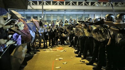 Riot police officers try to stop protesters from moving forward on a pro-democracy protest encampment in the Mongkok district of Hong Kong early Sunday, October 19, 2014. Vincent Yu/AP Photo