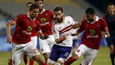 Zamaleks Basem Morsi, centre, tries to dribble through Al Ahly's Saad Samir, left and Moamen Zakaria, right, during their Egyptian Premier League match on Tuesday. Amr Abdallah Dalsh / Reuters