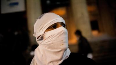 A masked protestor stands in front of the state assembly building during a protest in Rio de Janeiro. AP Photo / Nicolas Tanner