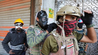 Iraqi protesters cover their faces during a demonstration in Baghdad's al-Rasheed street near al-Ahrar bridge. AFP