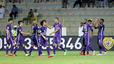 Al Ain players celebrate scoring a goal during their Arabian Gulf League football match against Al Wasl at Zabeel Stadium in Dubai. Al Ain have won three times in as many games to open the season. Ashraf Al Amra /Al Ittihad