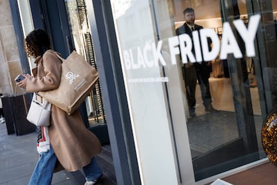 A woman leaves a shop on Oxford Street during Black Friday shopping. Which? found 92 per cent of 227 products in last year’s Black Friday fortnight were the same price or cheaper at other times of the year. EPA