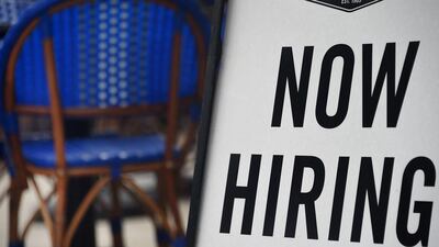 A restaurant in Arlington in the US state of Virginia displays a 'Now Hiring' sign. About 916,000 new jobs were created in March, the highest level in seven months, as business that closed to stem the spread of Covid-19 reopened. AFP