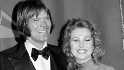 In this February 15, 1979 file photo, country singers Glen Campbell, left, and Tanya Tucker, engaged to one another, are shown at the Grammy Awards in Los Angeles. AP