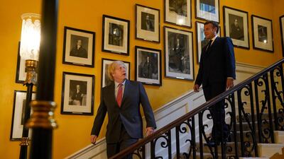 British Prime Minister Boris Johnson welcomes French President Emmanuel Macron during a visit at Downing Street in London. Reuters