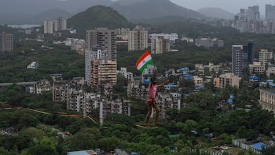 Tightrope artist Harshdeep Pawar carries the Indian flag while making a high-wire walk above the west coast city of Mumbai, to mark Independence Day. AP