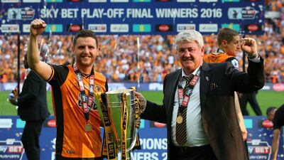 Father and son Alex Bruce, left, and Steve Bruce celebrate after Hull gained promotion back to the Premier League with a 1-0 win over Sheffield Wednesday in Saturday's Championship play-off final. Alex Livesey / Getty Images