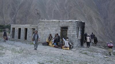 Flood-affected residents of Gozargah-e-Noor district in Baghlan province receive donations from Afghan chief executive Abdullah Abdullah in June 8, 2014, when he was campaigning for the presidency. Massoud Hossaini / Reuters