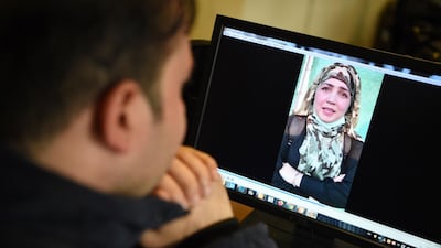 A man watches a video of Afghan woman Muzghan, who walked free from jail in September after confessing to being members of the Taliban's ultra-violent Haqqani network. AFP