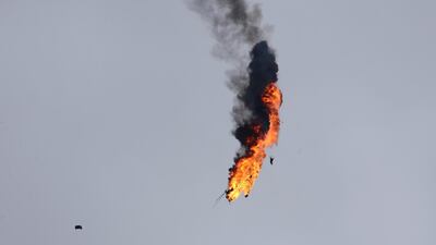 A Syrian government helicopter bursts in flames after it was hit by a missile in Idlib province on February 11, 2020. AP