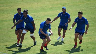 Samoa's centre Kieron Fonotia, centre, practices with teammates. AFP