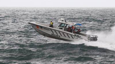 Members of the Dominican Republic Navy and civil protection authorities conduct a search operation for a teenager who went missing during Tropical Storm Melissa, in Santo Domingo. Reuters