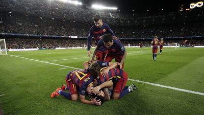 Barcelona's Luis Suarez, bottom, celebrates with his teammates after scoring the second, winning goal against Bayer Leverkusen in the Champions League on Tuesday night. Emilio Morenatti / AP