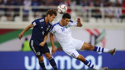 Sho Sasaki of Japan and Dostonbek Khamdamov of Uzbekistan jump for a header. Getty Images