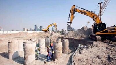 Land moving equipment and hand crews work on the footing piers where a giant flag pole will be erected in Sharjah. Mike Young / The National