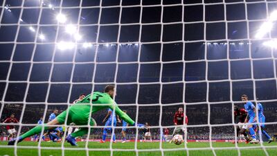 AC Milan's Rafael Leao scores their first goal past Atletico Madrid's Jan Oblak. AFP
