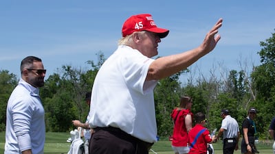 Mr Trump waves while greeting golfers at the driving range before the start of the second round of the 2023 LIV Golf DC. EPA