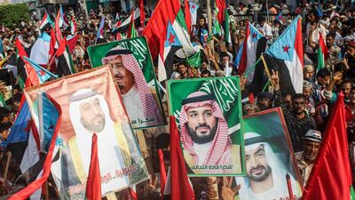 People carry portraits of Saudi and UAE leaders during a rally in support of the Arab Coalition in Yemen's southern port city of Aden on September 5, 2019. AFP