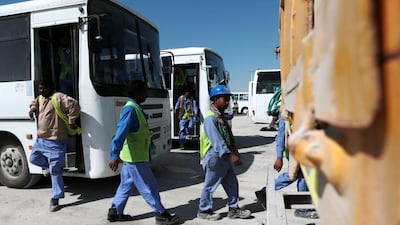 Workers arrive at the mess hall for their lunch break. Christopher Pike / The National