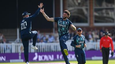 England bowler Reece Topley celebrates with Jason Roy after dismissing Shikhar Dhawan for nine. Getty