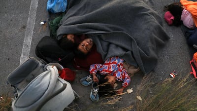 A family sleeps at a parking space, following a fire at the Moria camp for refugees and migrants on the island of Lesbos, Greece. Reuters