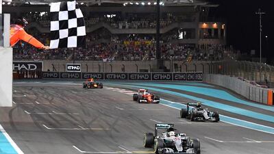 Mercedes AMG Petronas F1 Team's British driver Lewis Hamilton crosses the finish line at the end of the Abu Dhabi Formula One Grand Prix at the Yas Marina circuit on November 27, 2016. Nico Rosberg won his maiden Formula One world title by securing second place behind his Mercedes arch-rival Lewis Hamilton in the Abu Dhabi Grand Prix. / AFP / Andrej ISAKOVIC