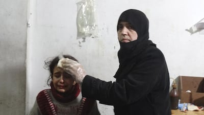 A woman tends to a wounded girl after what activists said was an airstrike by forces loyal to Syria’s president Bashar Al Assad, in the Damascus suburb of Saqba on December 26, 2014. Reuters