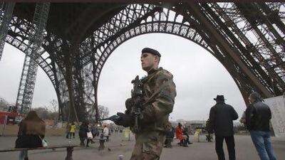 A French soldier patrols under the Eiffel Tower. France has tightened security in public buildings and transport following its military intervention against Al Qaeda-linked rebels in Mali