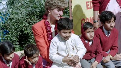 Princess Diana of Wales poses with Indian children as she visits the Agra chapter of the London-based Marie Stopes family planning clinic on February 11, 1992. AFP