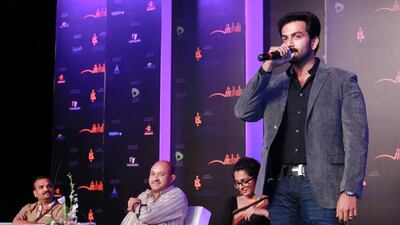Parvathy, in a black sari, and Prithviraj, standing at the Sharjah book festival. Victor Besa for The National