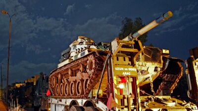 A Turkish military convoy of tanks and armoured vehicles passes through the town of Binnish towards Syria’s Idlib province on February 7, 2020. AFP